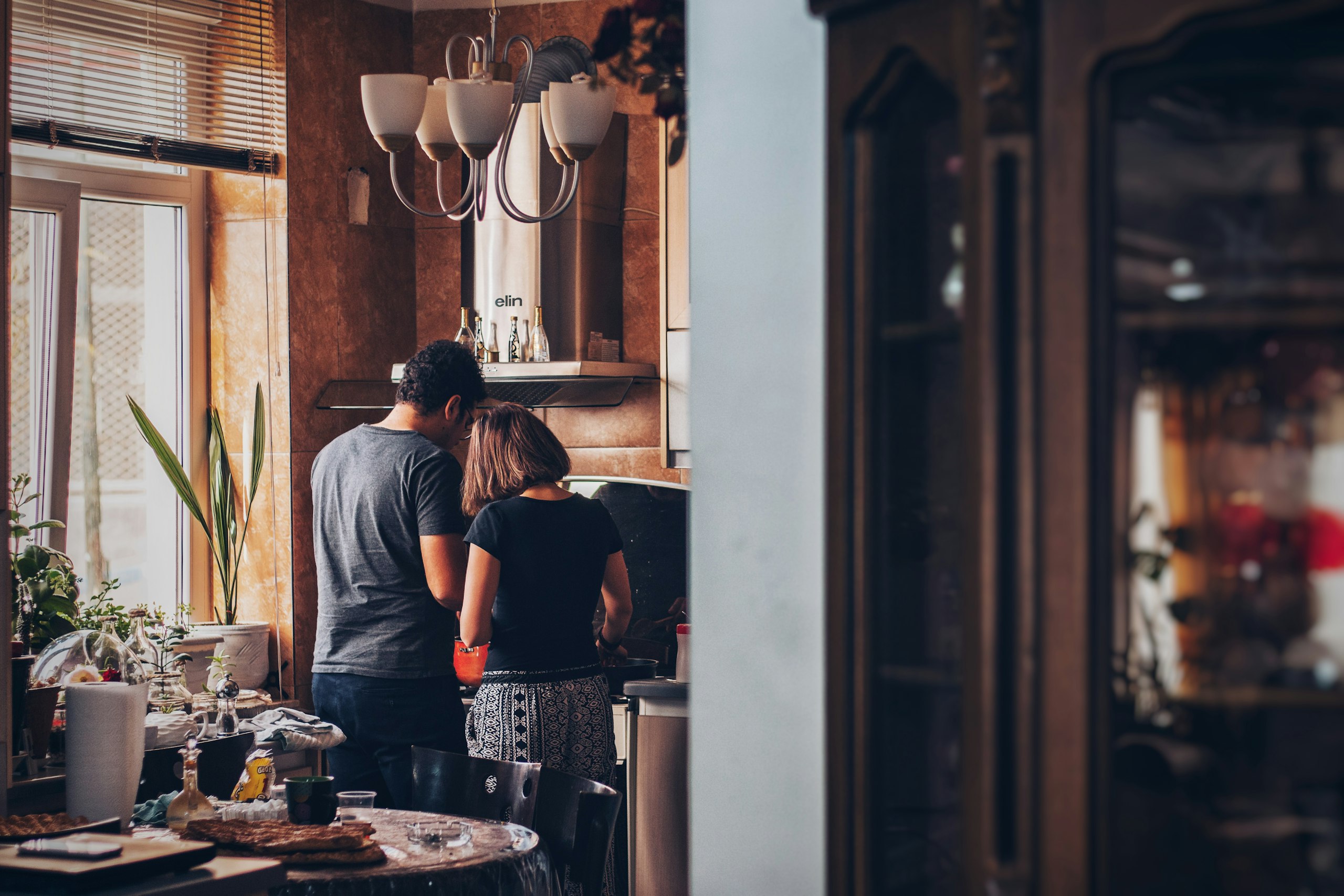 division of labour in marriage - couple sharing the load in the kitchen